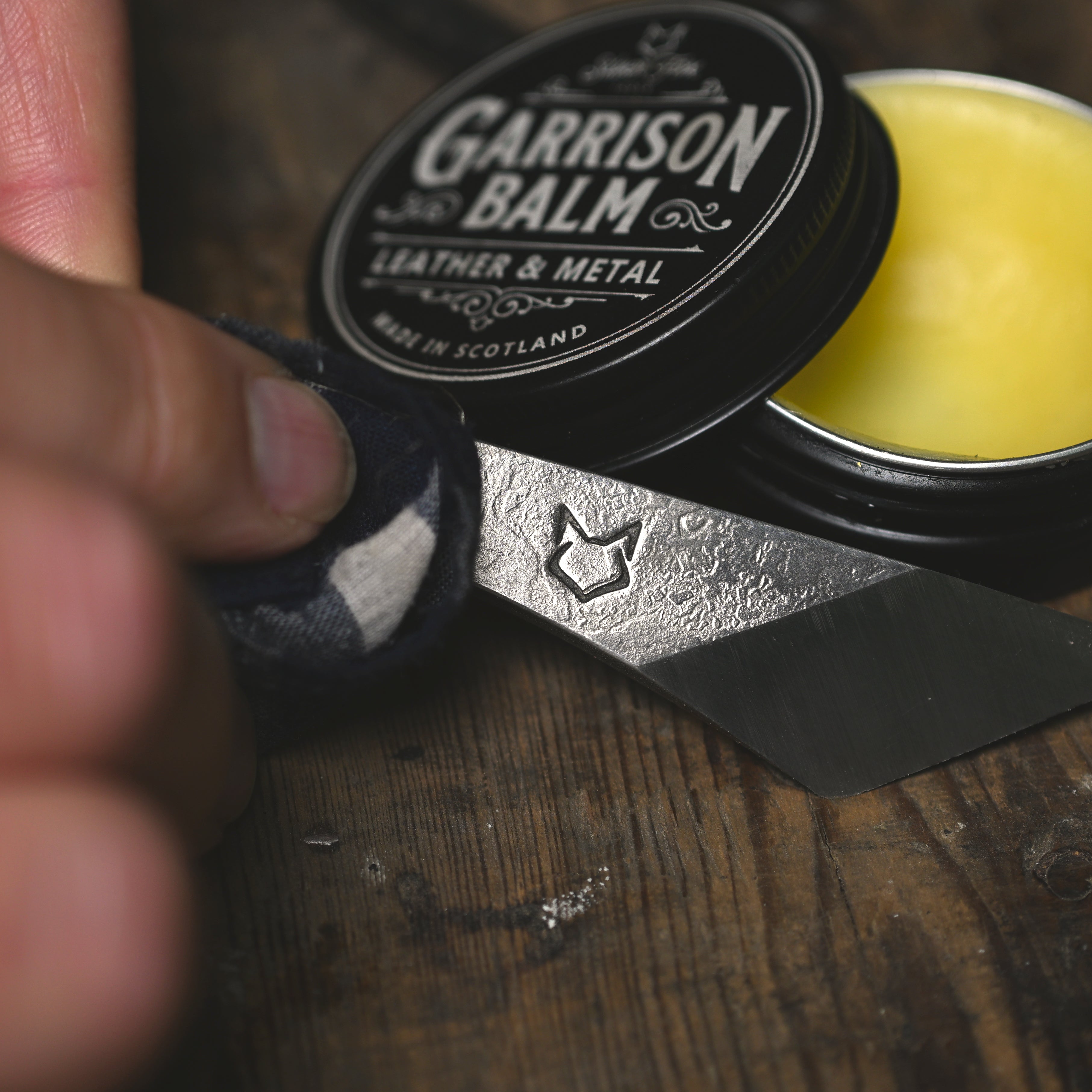 Garrison balm being applied to a Kitsune knife from Silver Fox Tools
