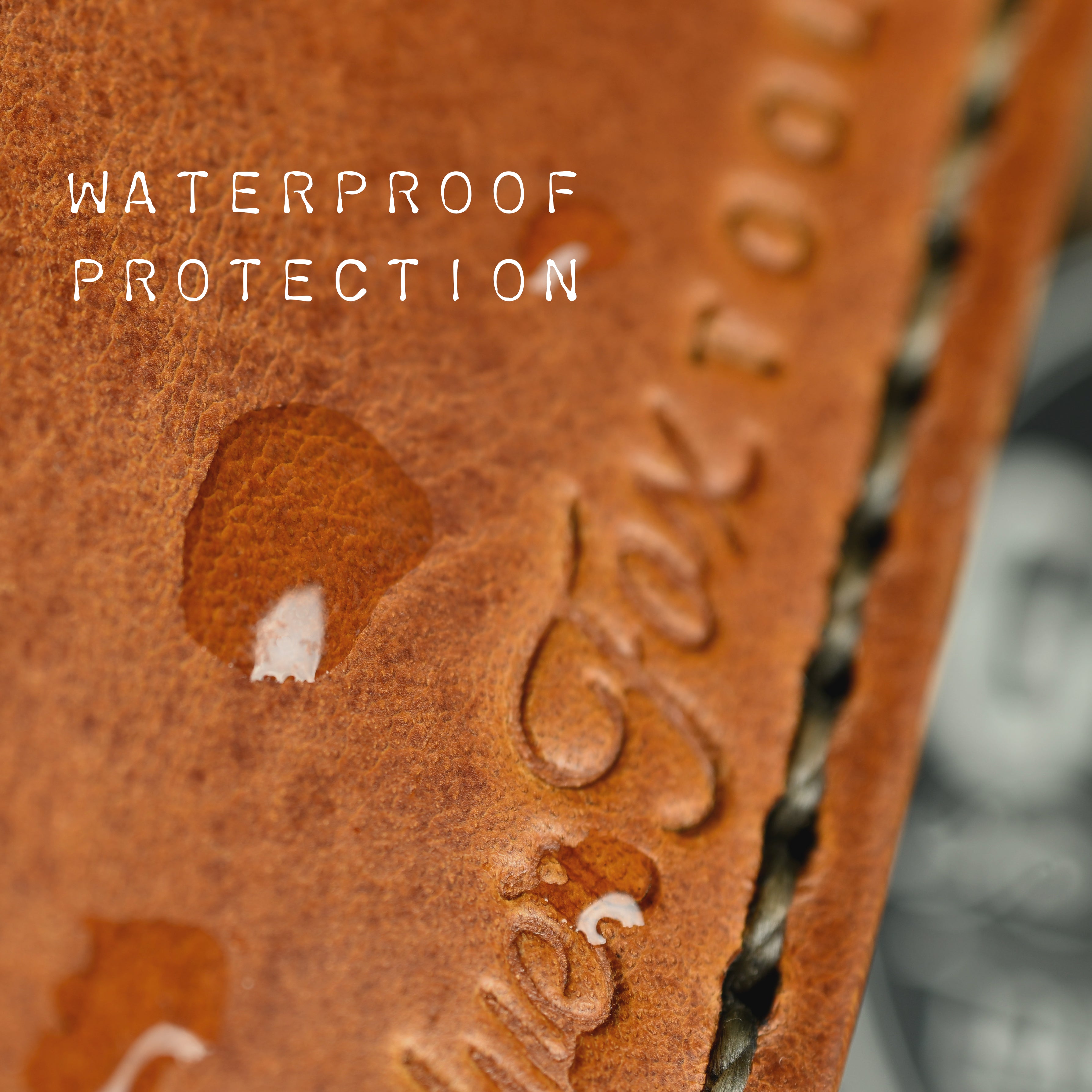 bead of water sitting on a leather wallet